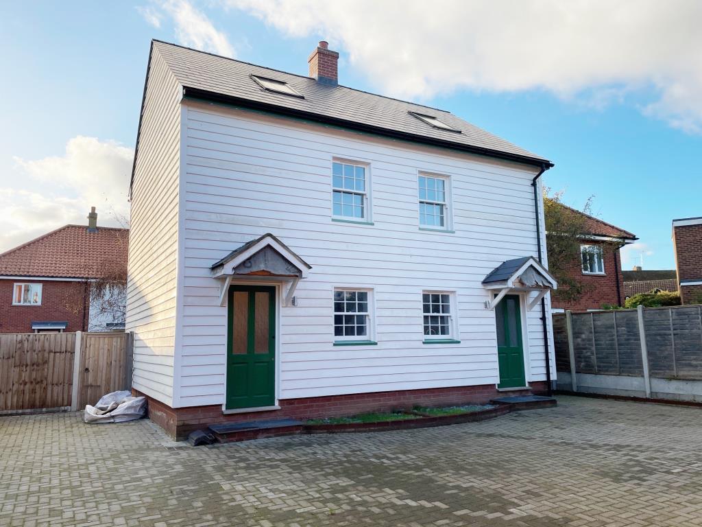 Lot: 77 - FREEHOLD TENANTED COMMERCIAL UNIT AND DEVELOPMENT OPPORTUNITY - front of the two cottages in need of finishing off